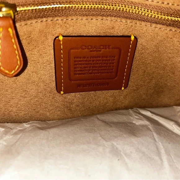 Coach Brown and Cream Tote Bag that is the sun that is casting spots on the bag - Picture 3 of 7